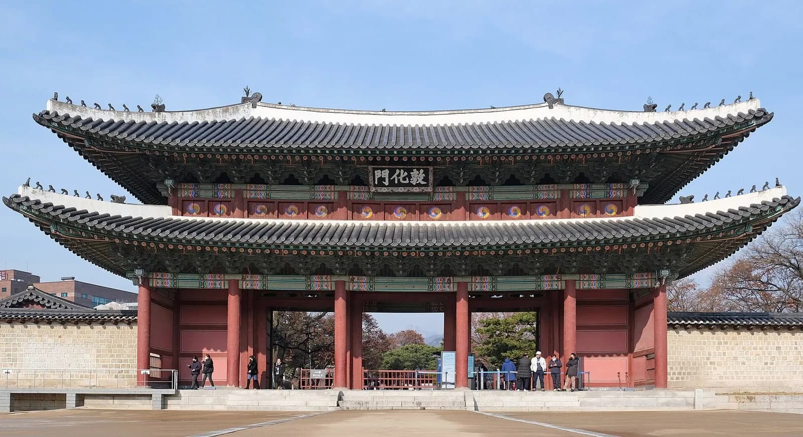 Donhwamun, the two-story wooden main gate of Changdeokgung Palace in Seoul, under a blue sky