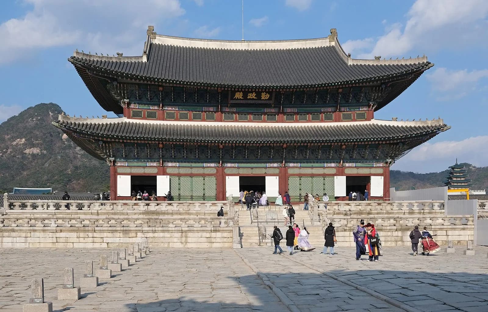 Geunjeongjeon throne hall at Gyeongbokgung Palace with visitors on the stone courtyard