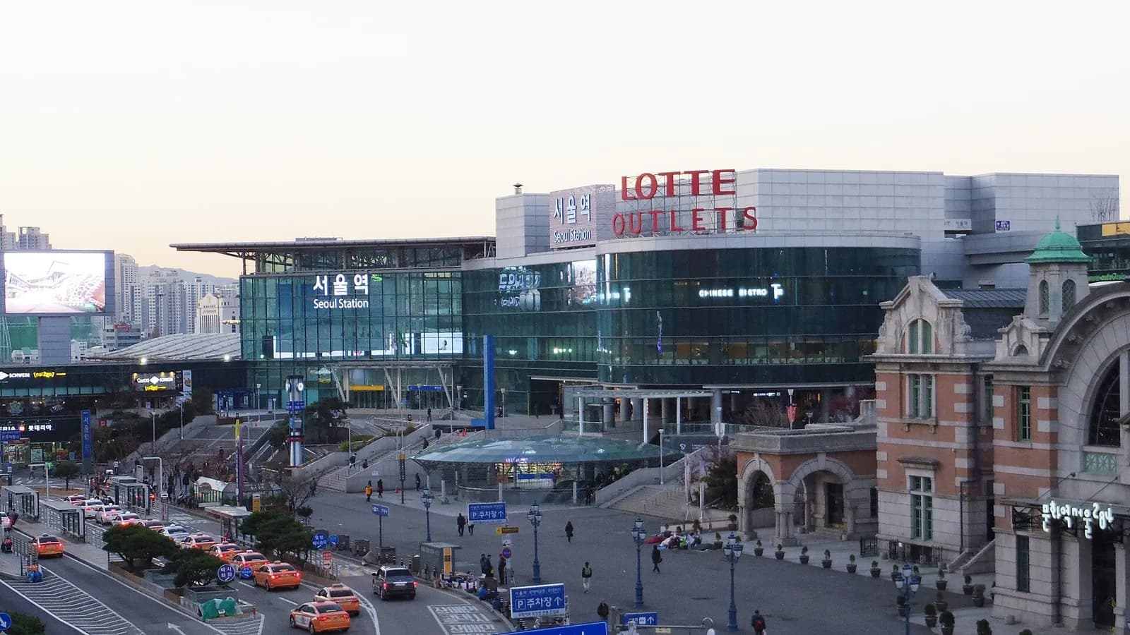 Seoul Station plaza with the glass terminal and the old brick station building