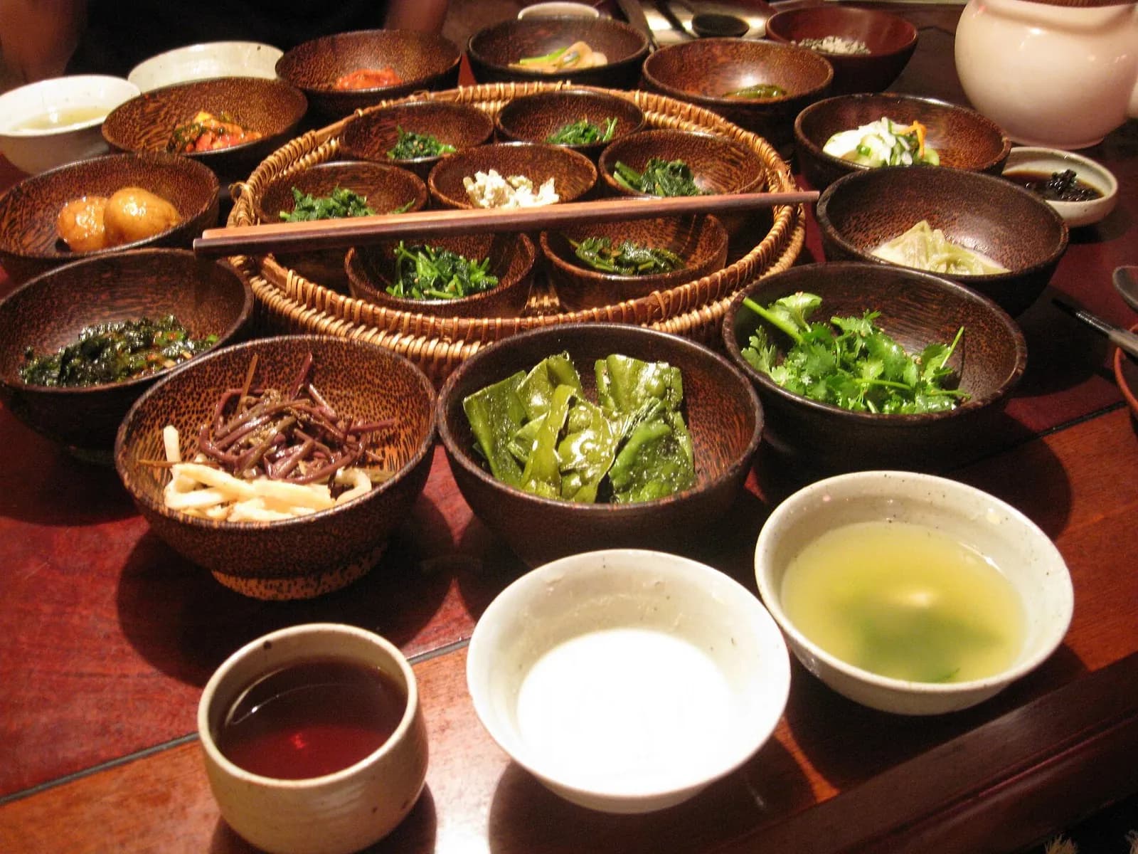 Korean temple food spread of many small vegetable dishes in wooden bowls in Insadong