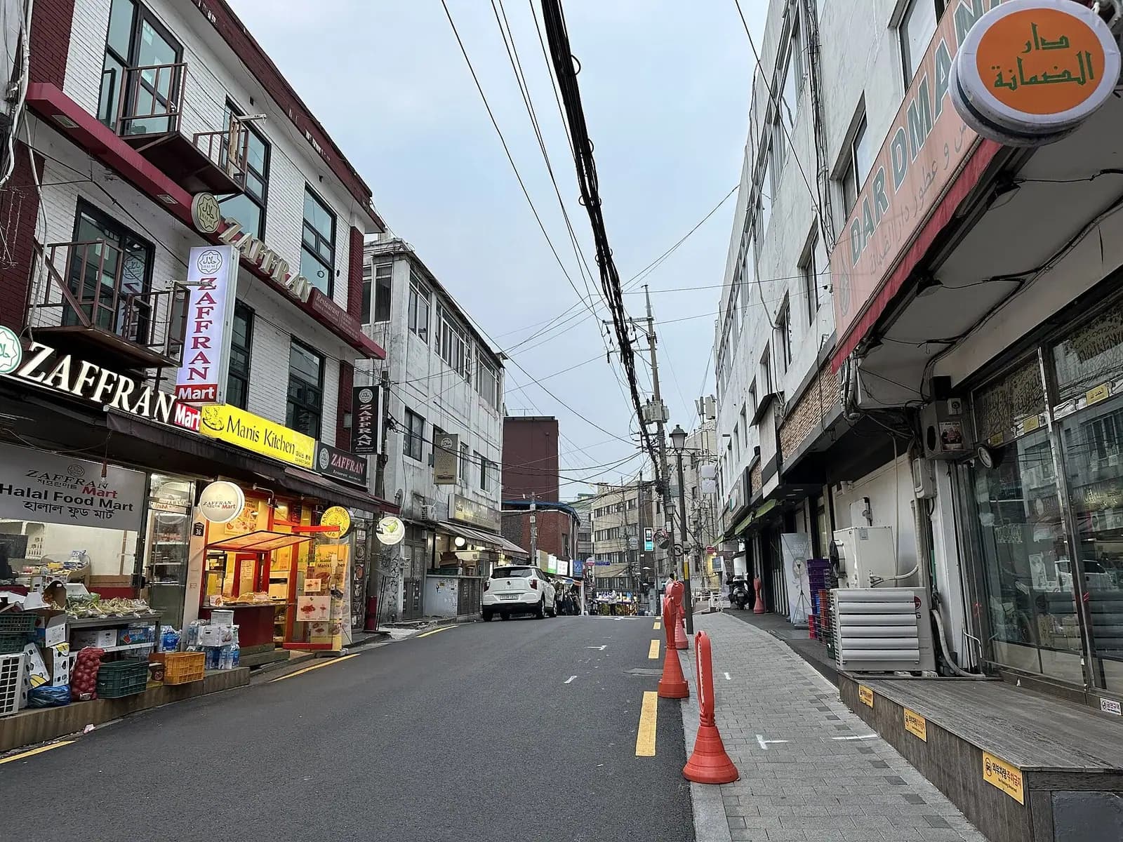 Street near Seoul Central Mosque lined with a halal food mart and restaurant signs