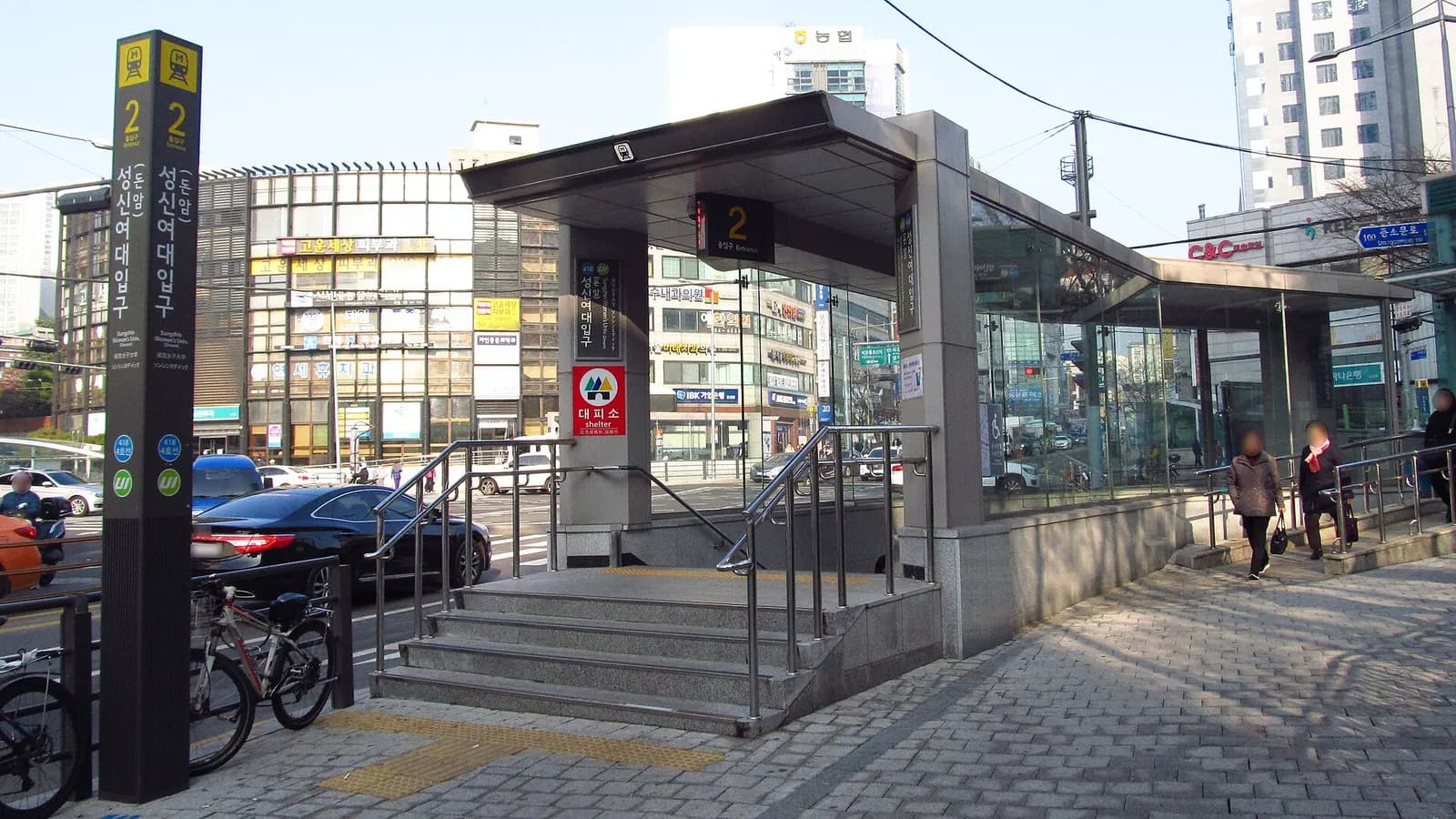 Exit 2 of Sungshin Women's University Station with shop buildings across the road